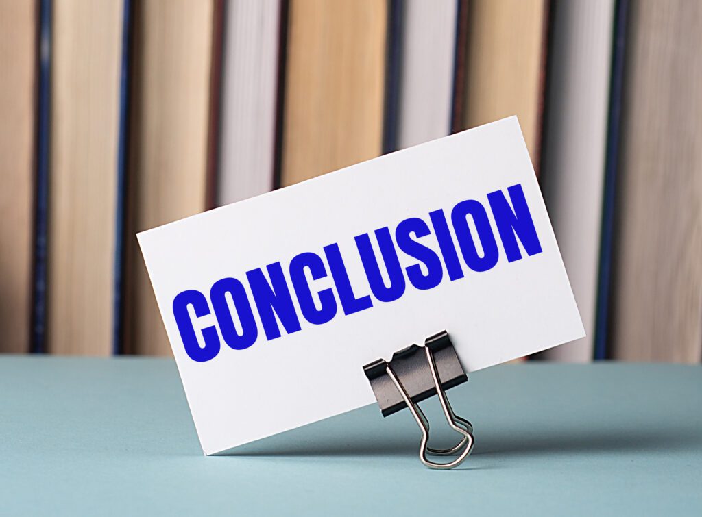 white card with text conclusion stands clip papers table against background books defocus